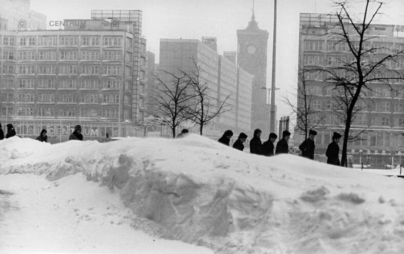 Grayscale Portrait Photo of Berliners Walking on the street in winter 1979.