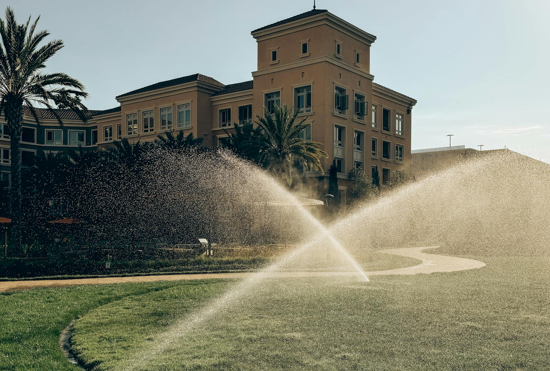 Sprinklers Watering Lawn near a house