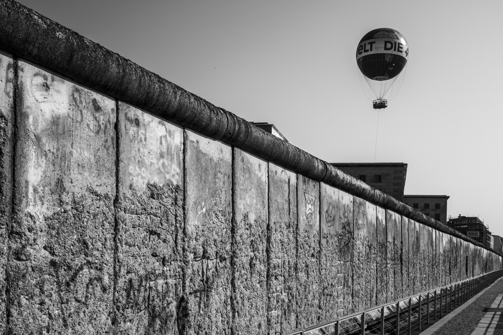 Grayscale Low angle view of balloon over Berlin Wall in Germany