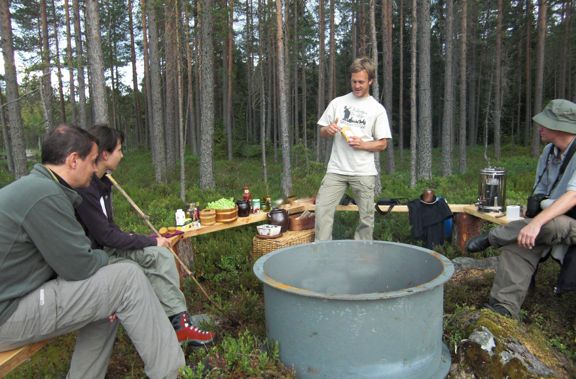 Campers sit around a fire at the Kolarbyn natural excursion