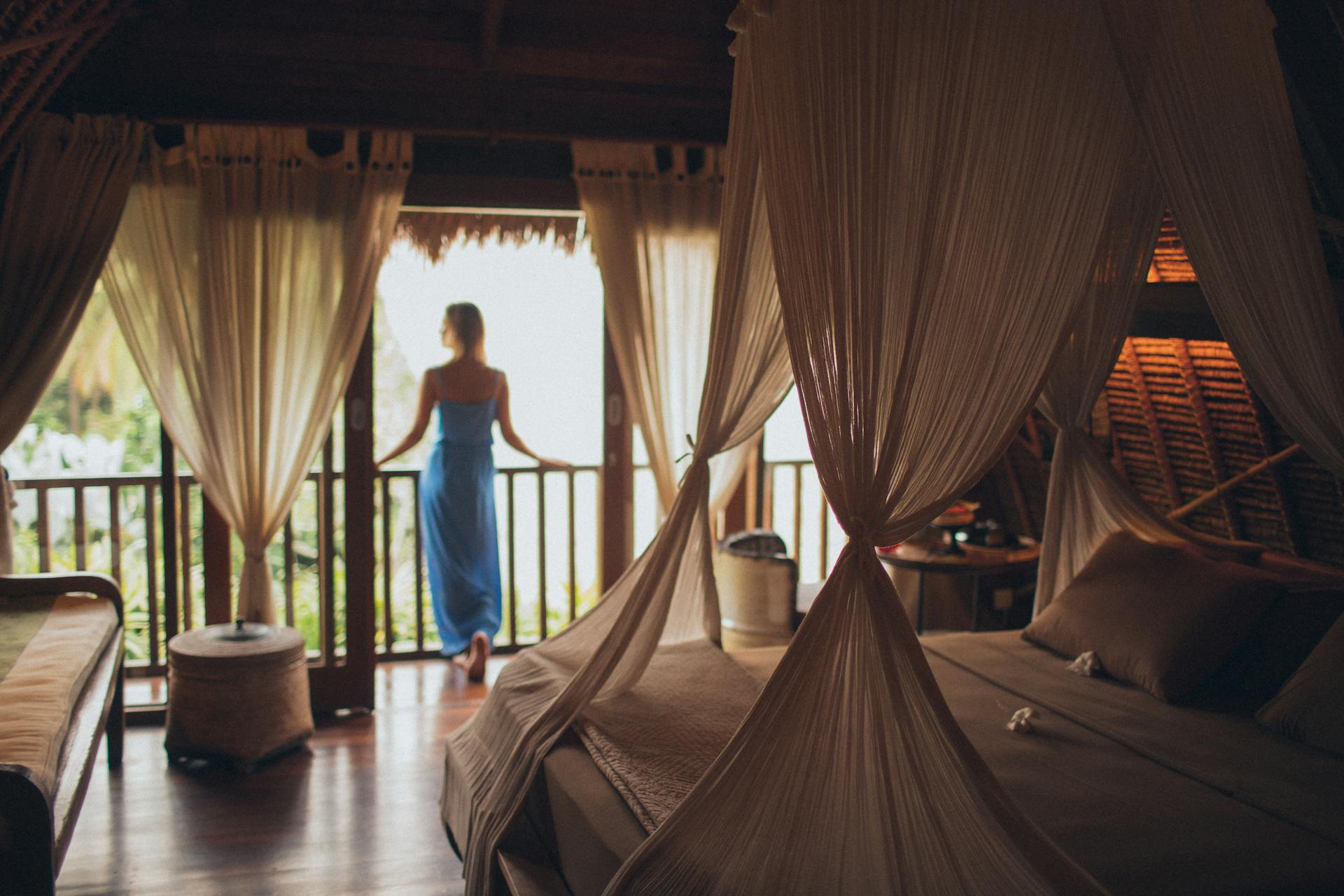 Woman standing on the balcony in a hotel room