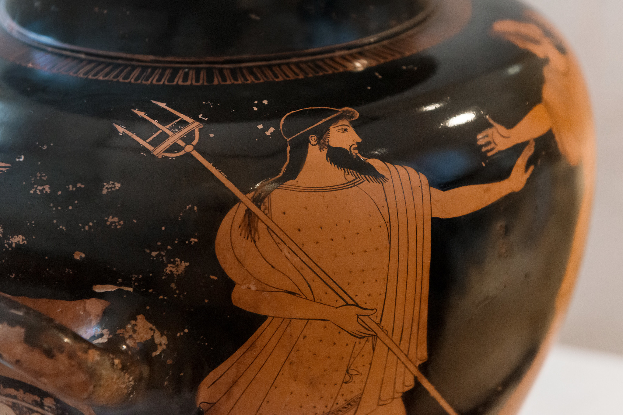 Poseidon with trident pursuing a woman