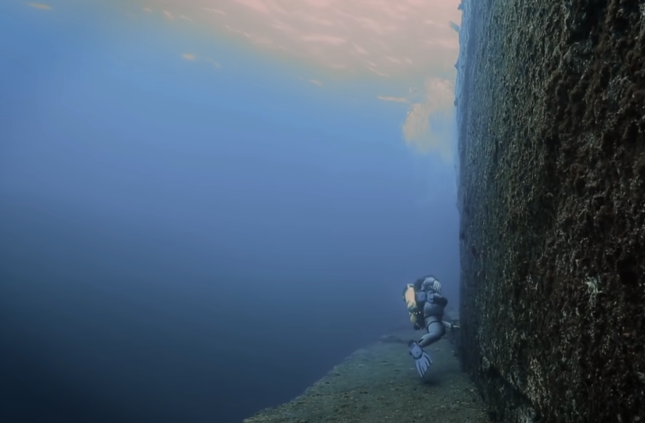 Diver diving at sunken city location