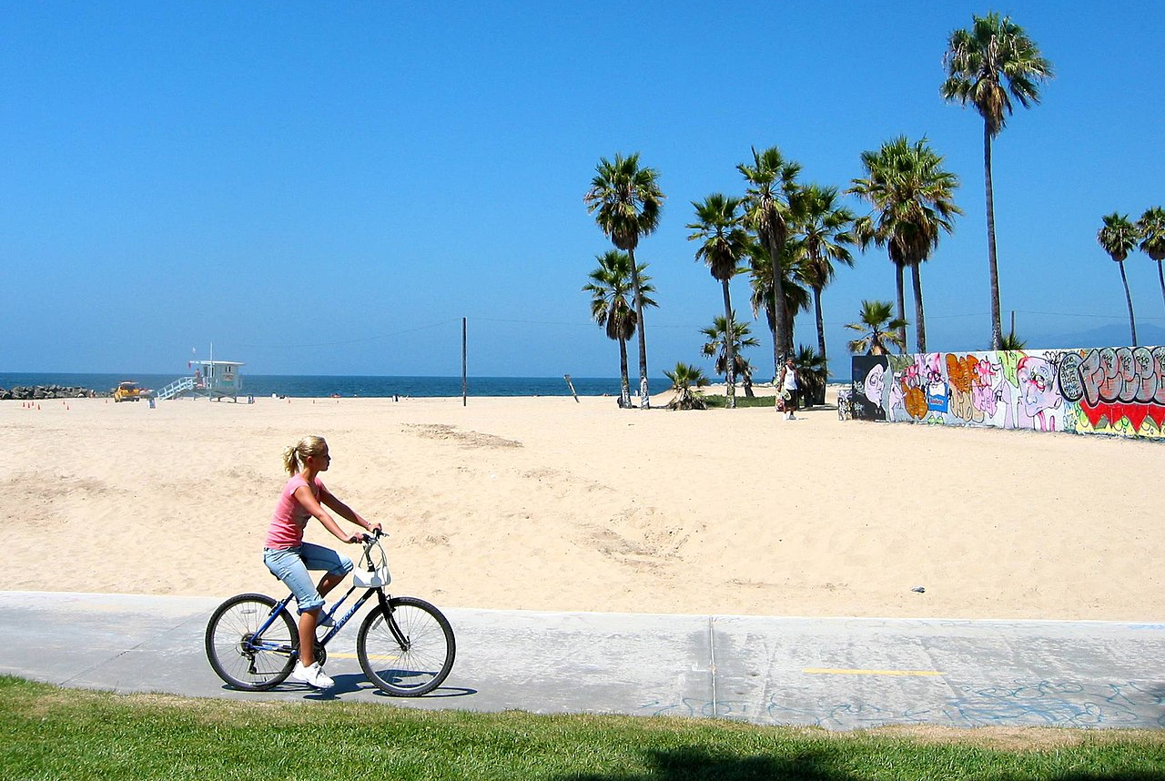 Woman riding a bicycle in Venice Beach, Los Angeles