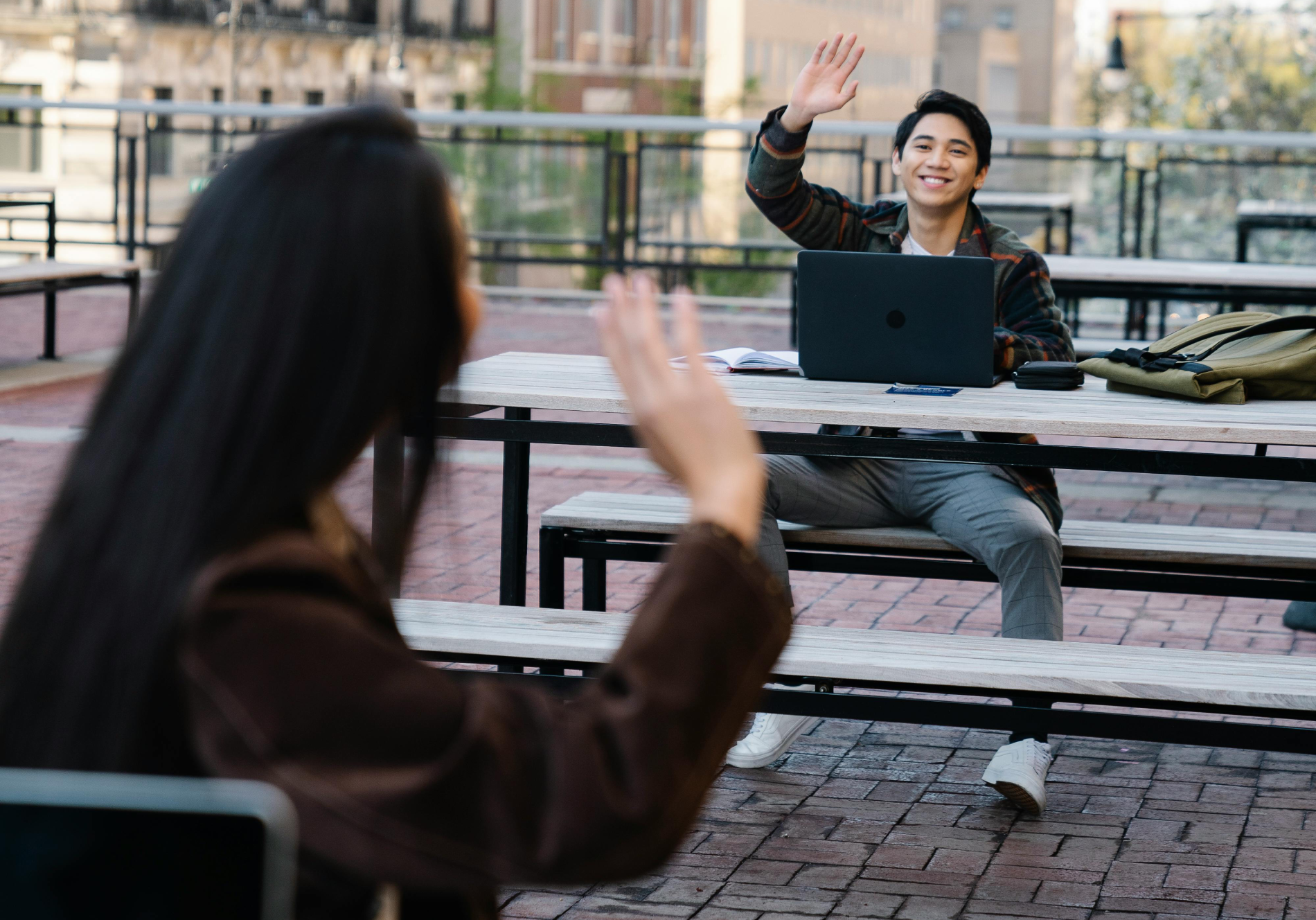A Man and a Woman Waving to Each Other