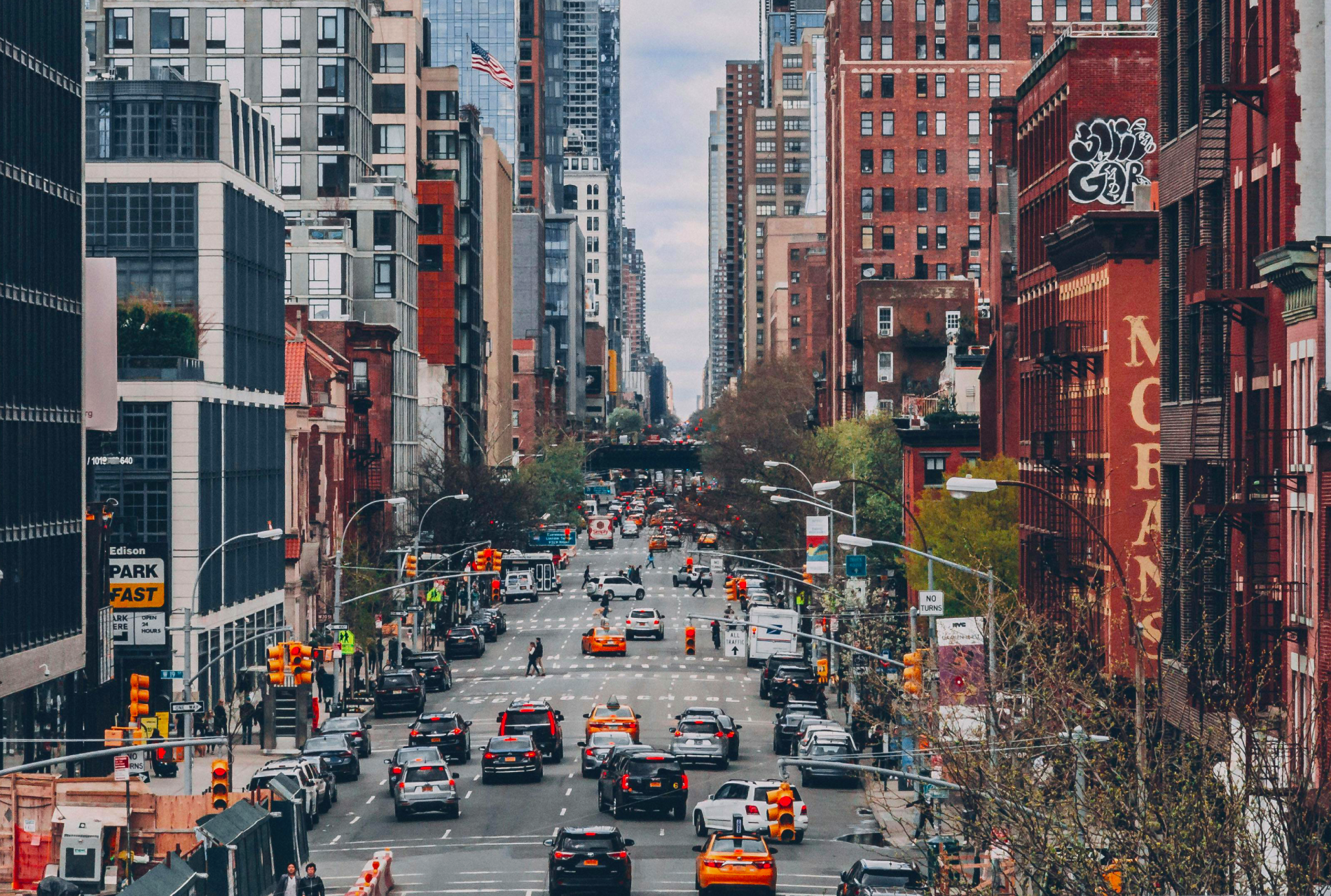Vehicles on Road Between High-rise Buildings