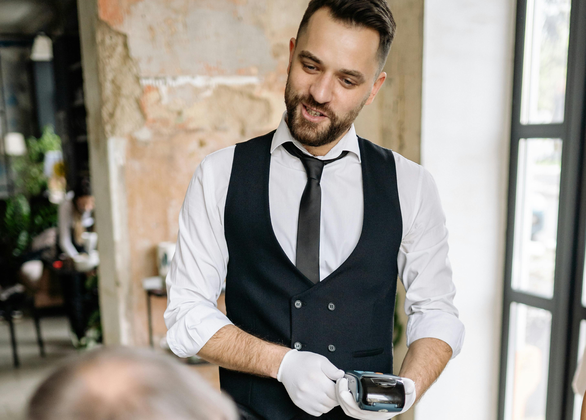 Waiter Holding a Credit Card Terminal