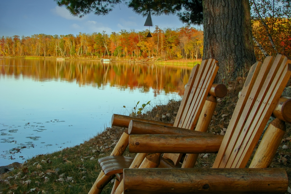 Cabin view of calm lake reflection with brightly autumn colored shoreline in the Chippewa National Forest, northern Minnesota USA