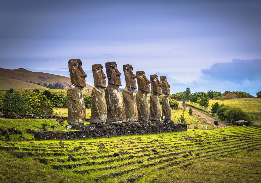 A line of majestic moai statues stand tall at Ahu Akivi on Easter Island