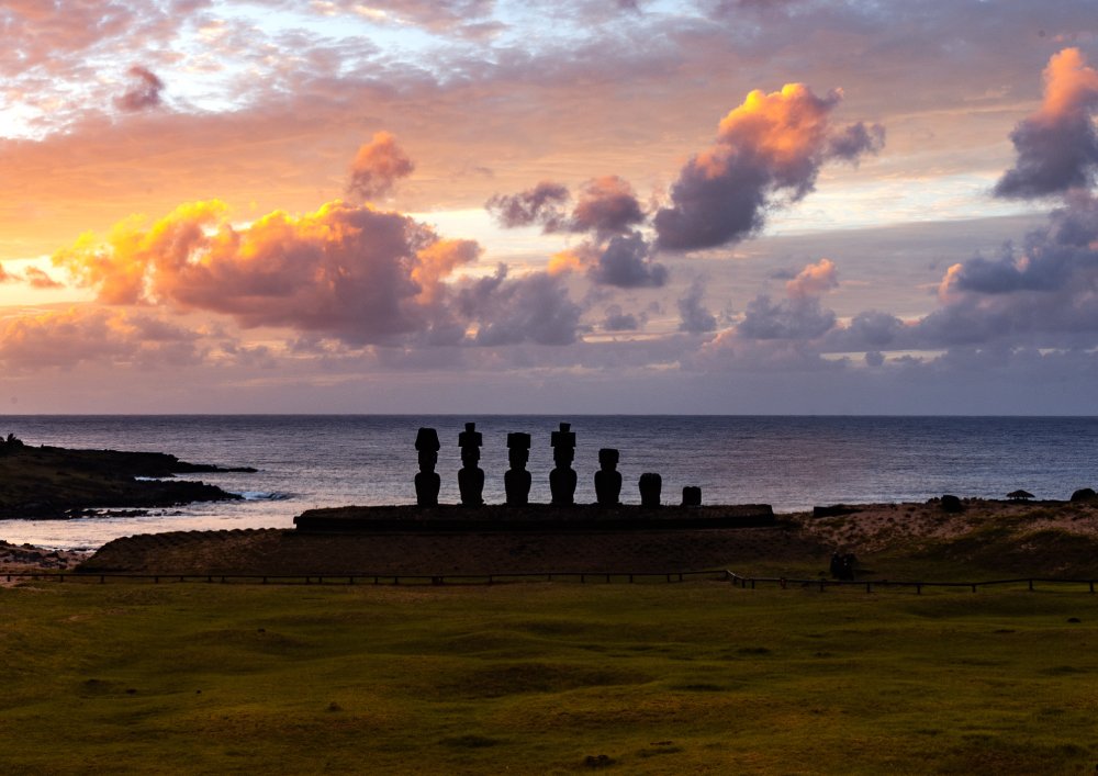 This image captures the iconic moai statues of Easter Island at sunset