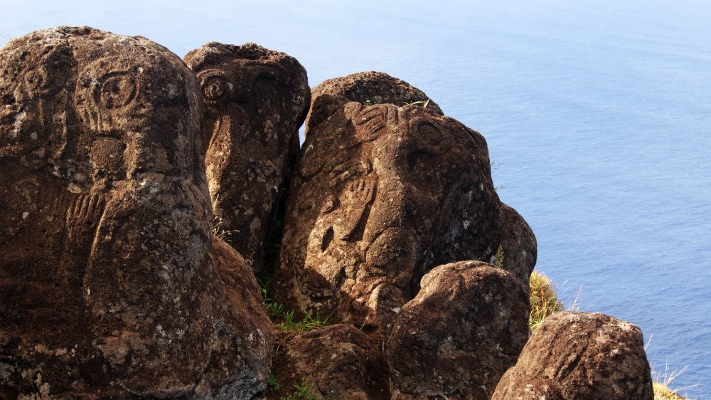 This image shows a group of petroglyphs carved into volcanic rock on Easter Island