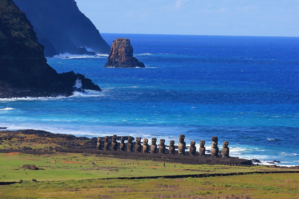 Easter Island, with a line of moai statues silhouetted against the vibrant sky