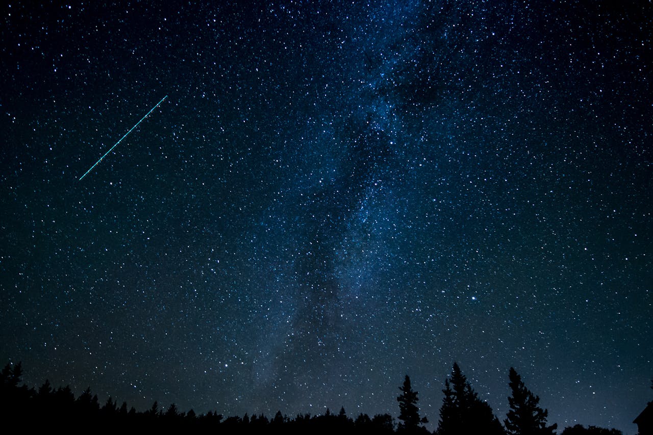 Night Photo of Starry expanse above a tranquil field.