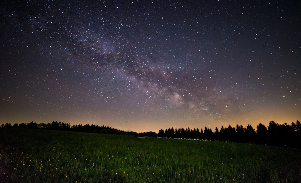 Night Photo of Starry expanse above a tranquil field