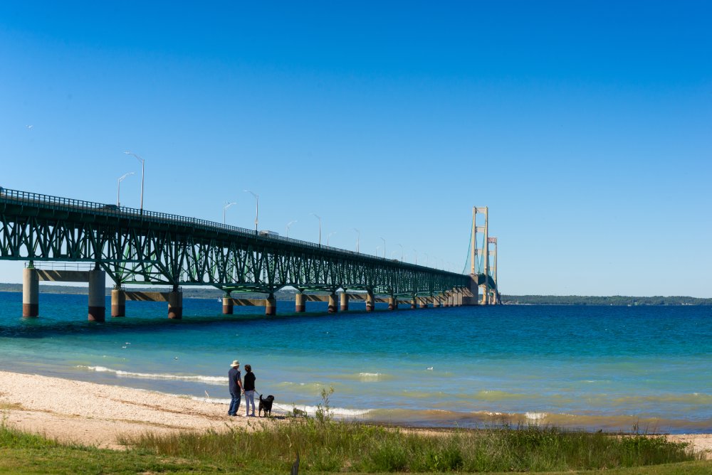 Photo of People Standing near the Mackinac Bridge