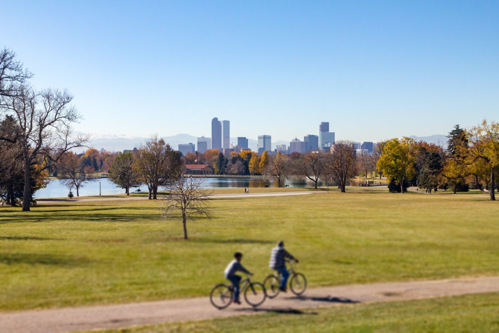 Denver Colorado downtown skyline with people riding bicycles