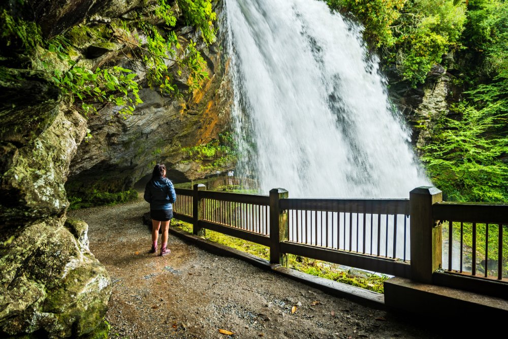 Woman Hiker Gazes on Dry Falls Water Fall, North Carolina