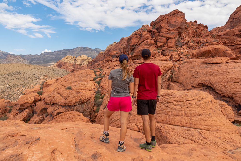 Couple standing on rocks with scenic view in Mojave Desert
