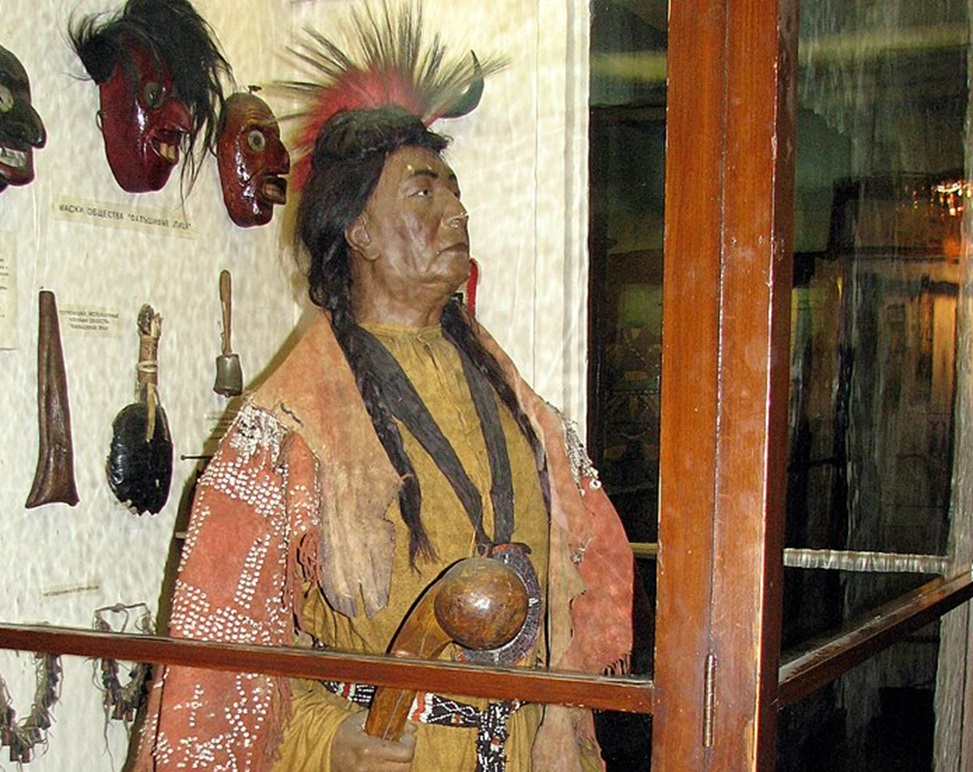 Culture of Iroquois. Tribal chief with a ritual rattle in hands.