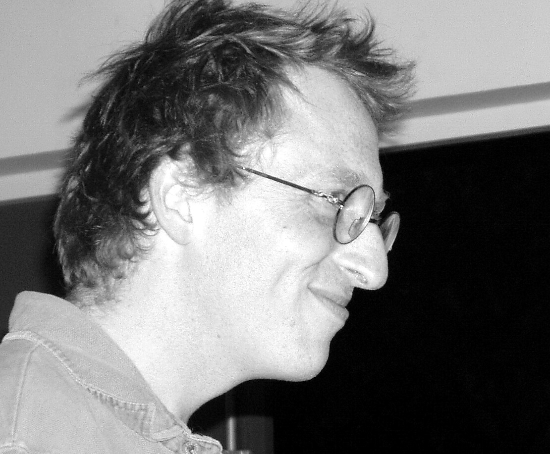 Grayscale Portrait Photo of Jon Ronson in gray outfit