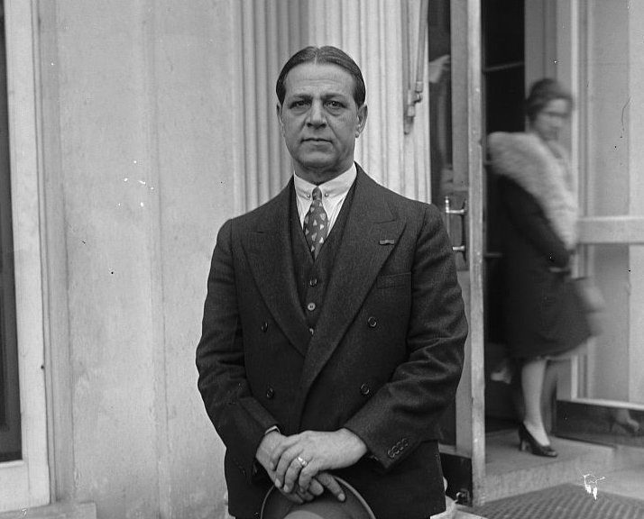 Grayscale Portrait Photo of Haig Patigian in a dark suit