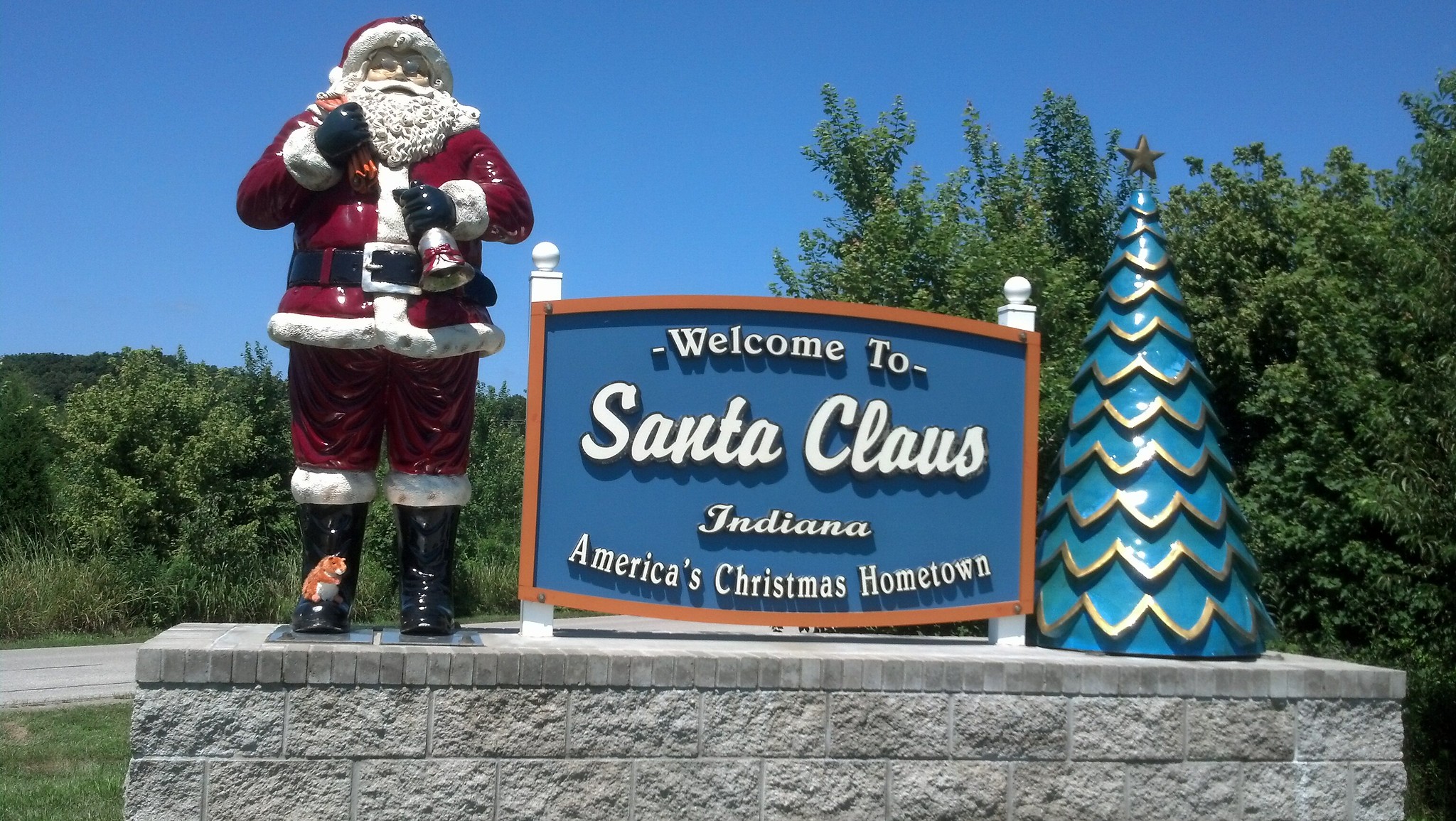 Squirrel with Santa Claus town sign