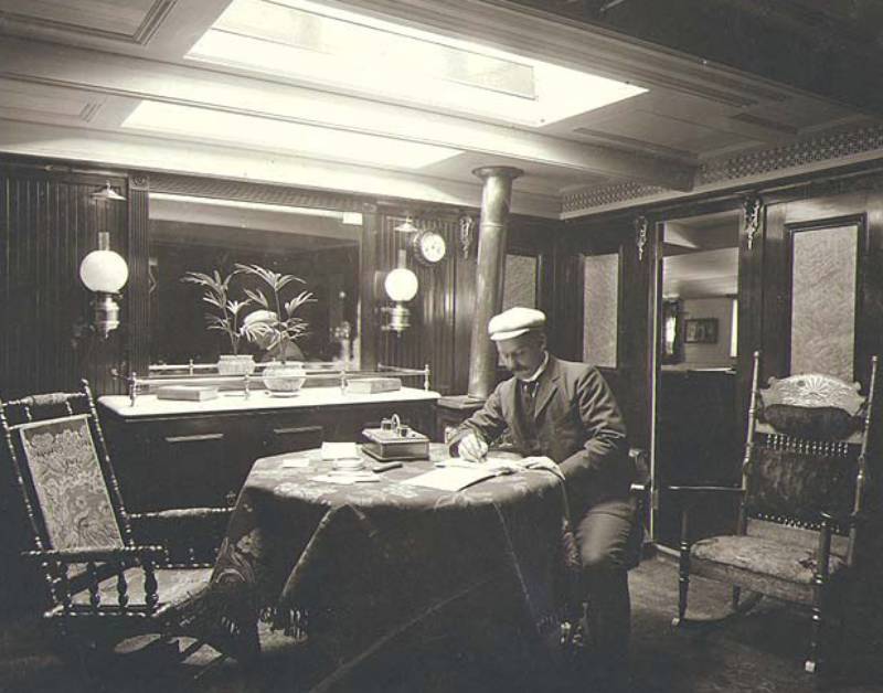 Crew member seated at a desk in one the interior cabins