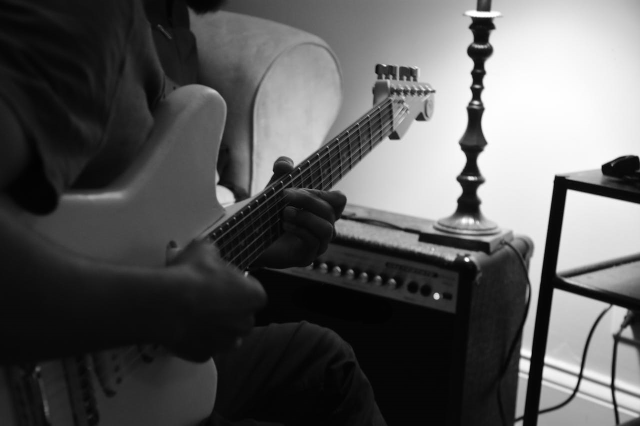 Man playing on electric guitar.