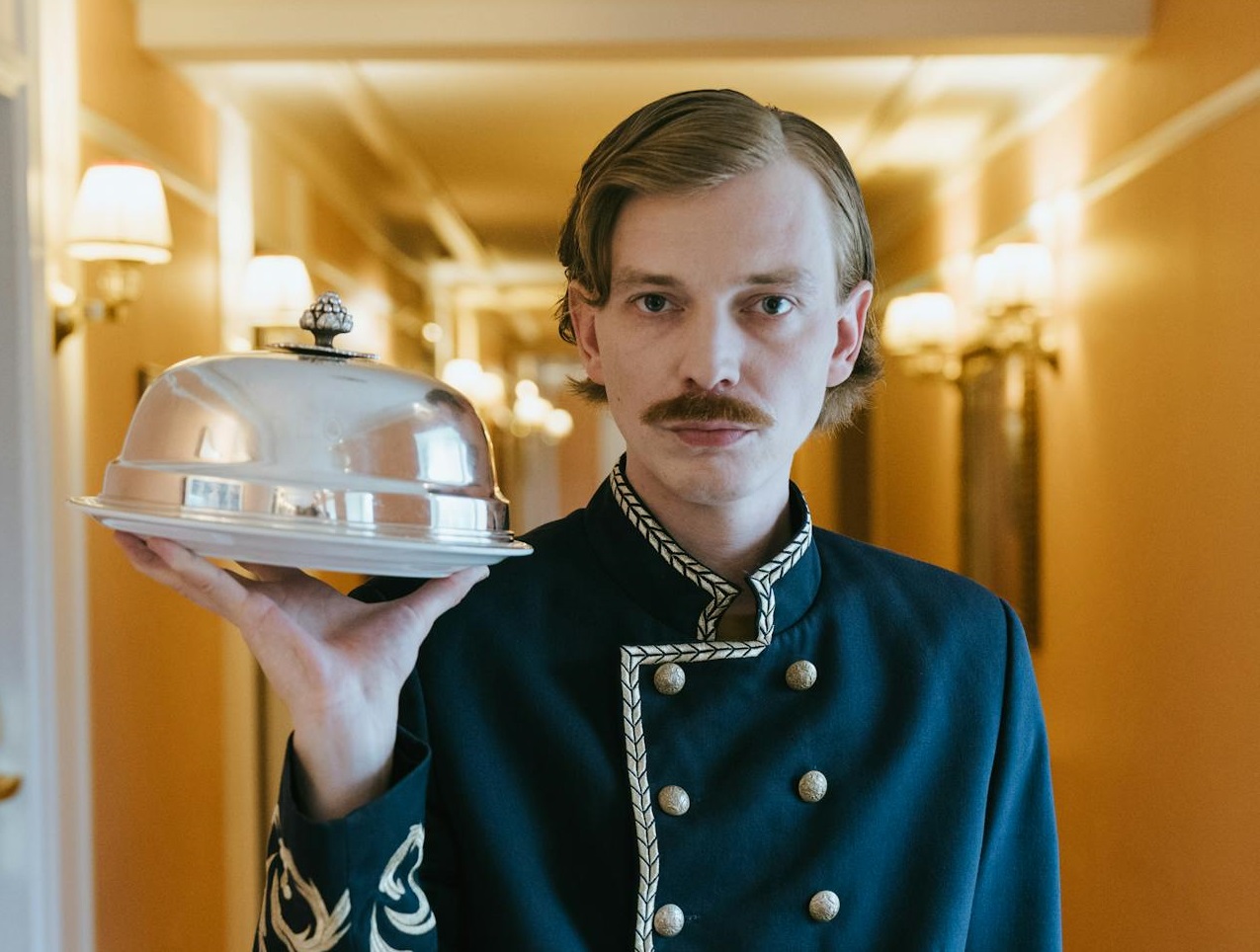 Guest Service Staff carrying a Cloche