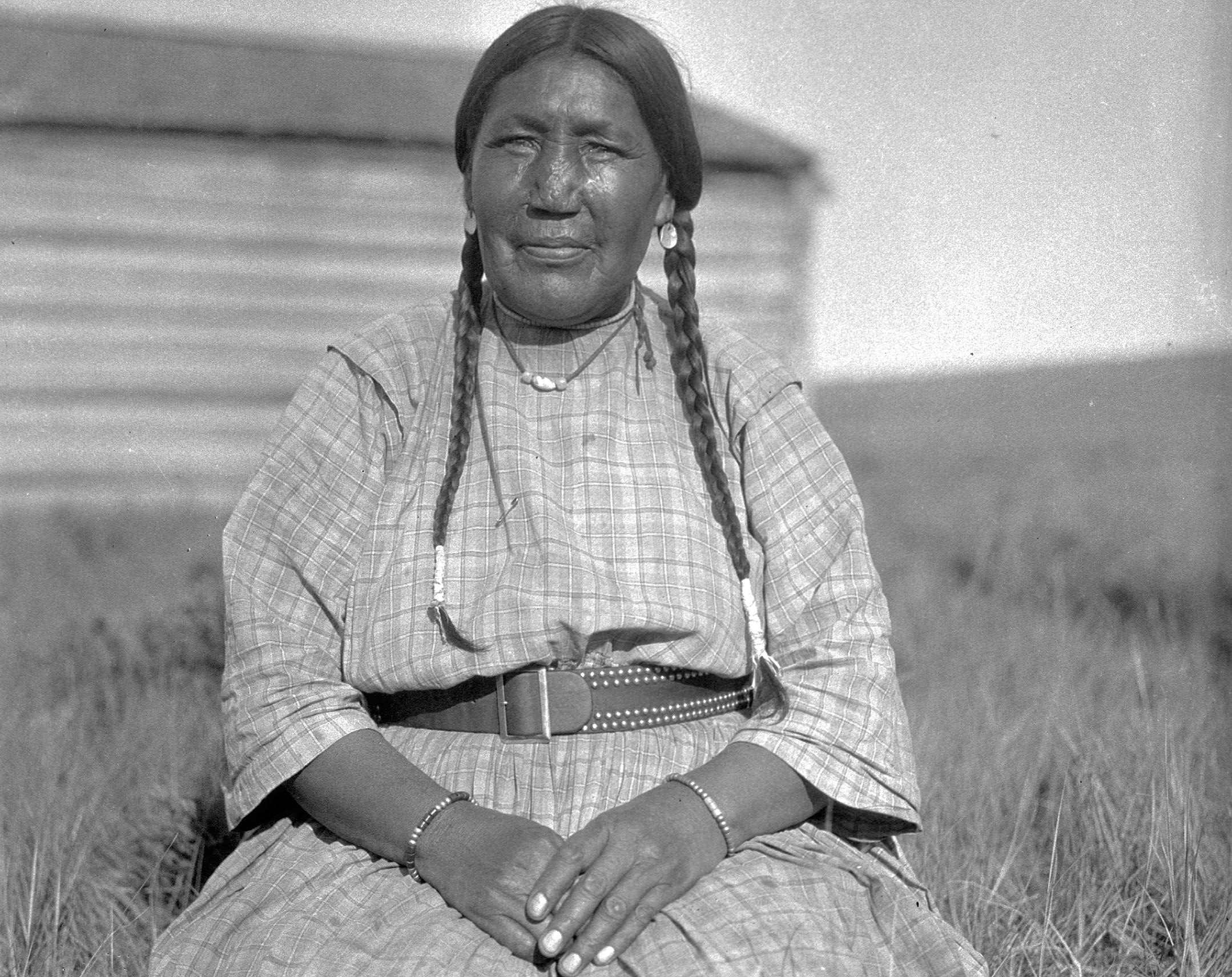 Blackfoot Woman with braids and jewels