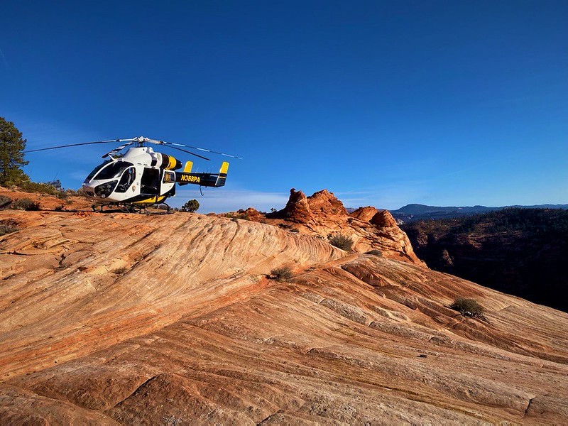 Helicopter 368 is seen on top of a slab of slanted rock during a shorthaul mission to Zion National Park