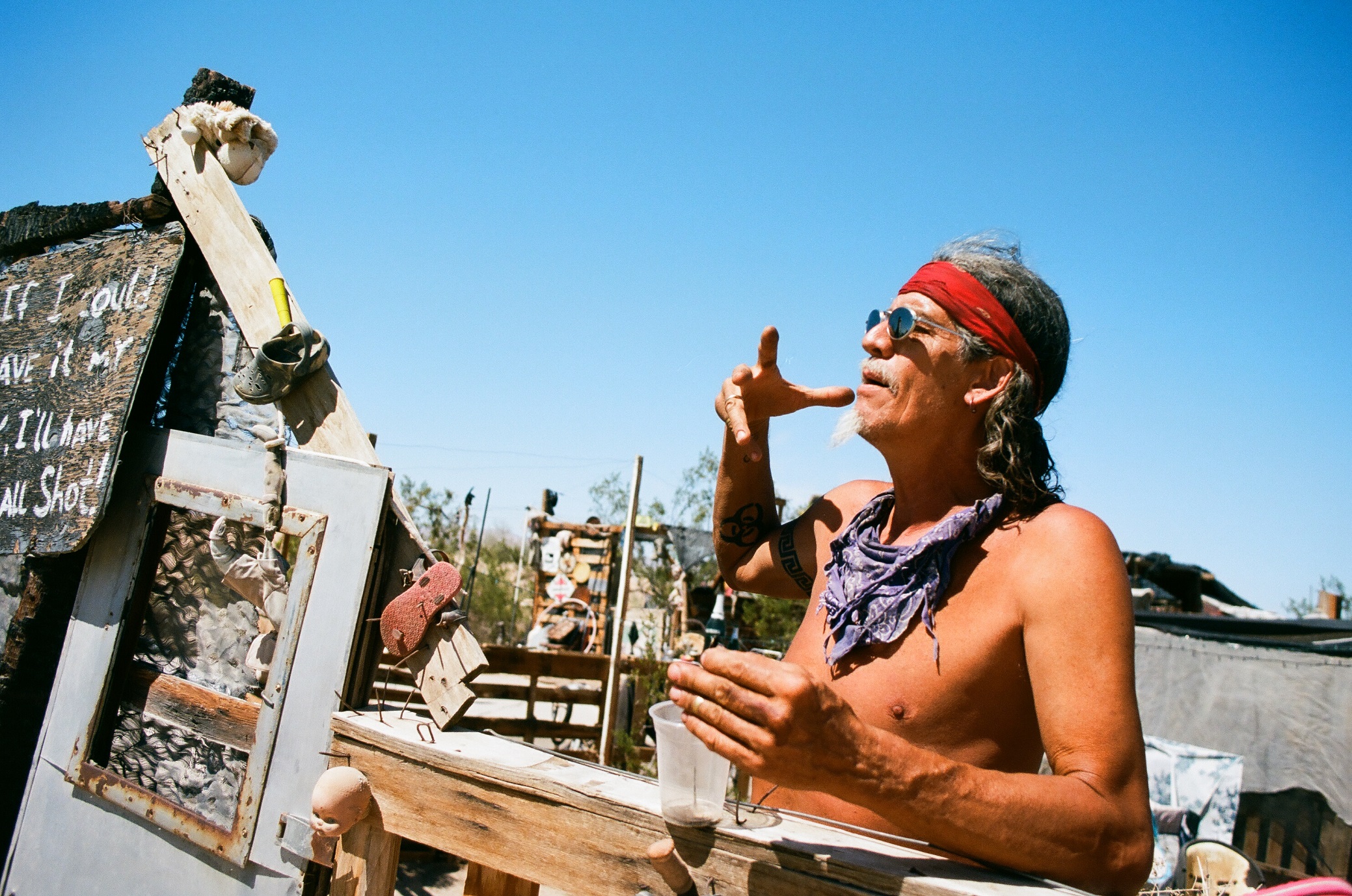 A man talks to visitors on the edge of his property - 2019