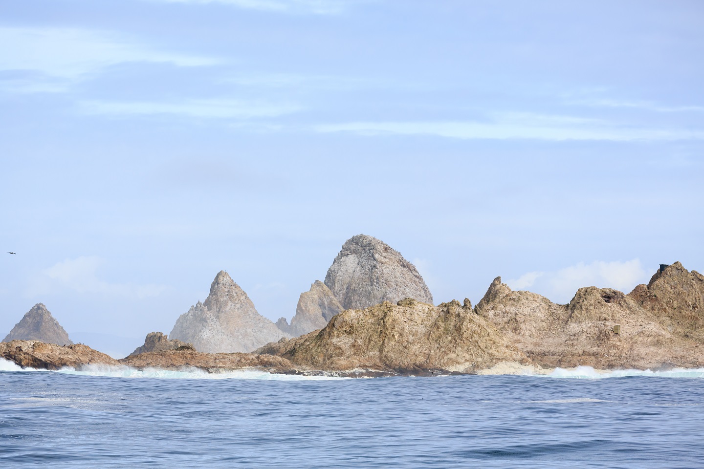 Group of Farallon Islands sea stacks off coast of San Francisco in the Gulf of Farallon on a sunny, clear day