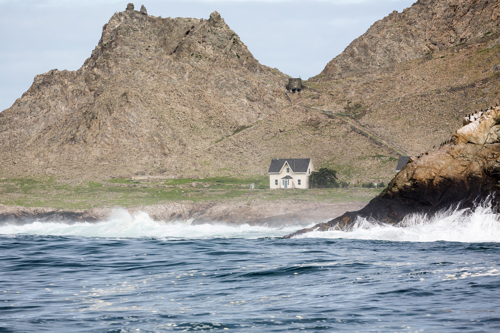 Farallon Islands lighthouse off coast of San Francisco in the Gulf of Farallon on a sunny, clear day