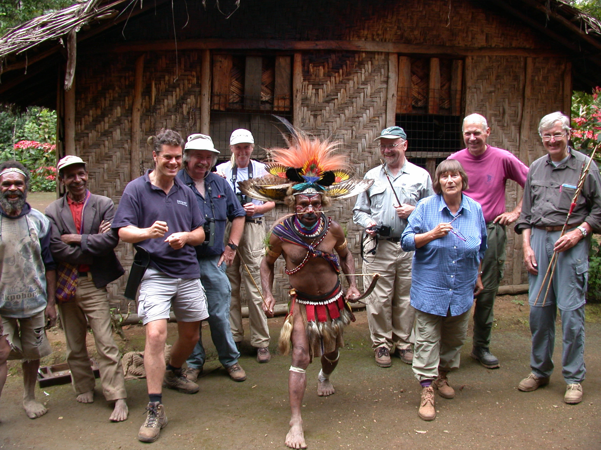 Huli wigman  in traditional clothes and tourists