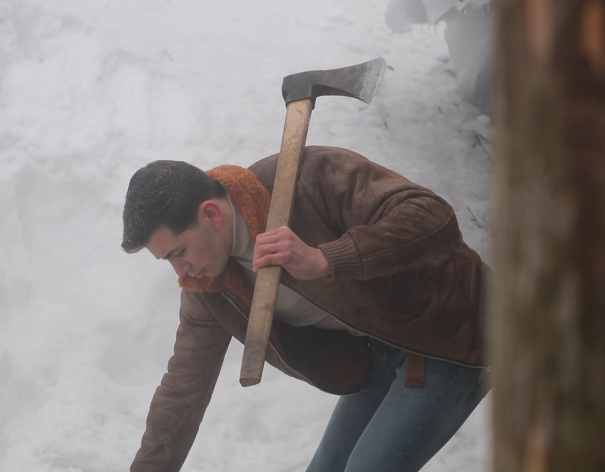 Man holding axe over his shoulder.