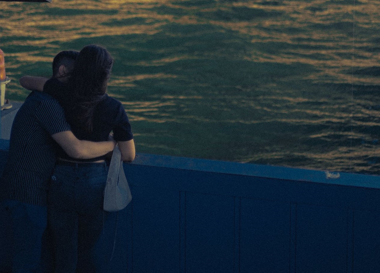 Couple standing on the bridge.