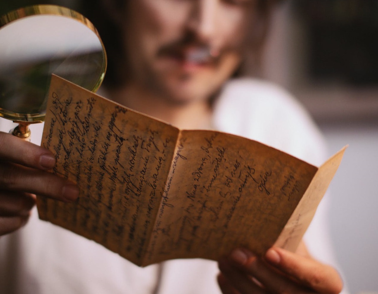 Man reading a handwritten letter.