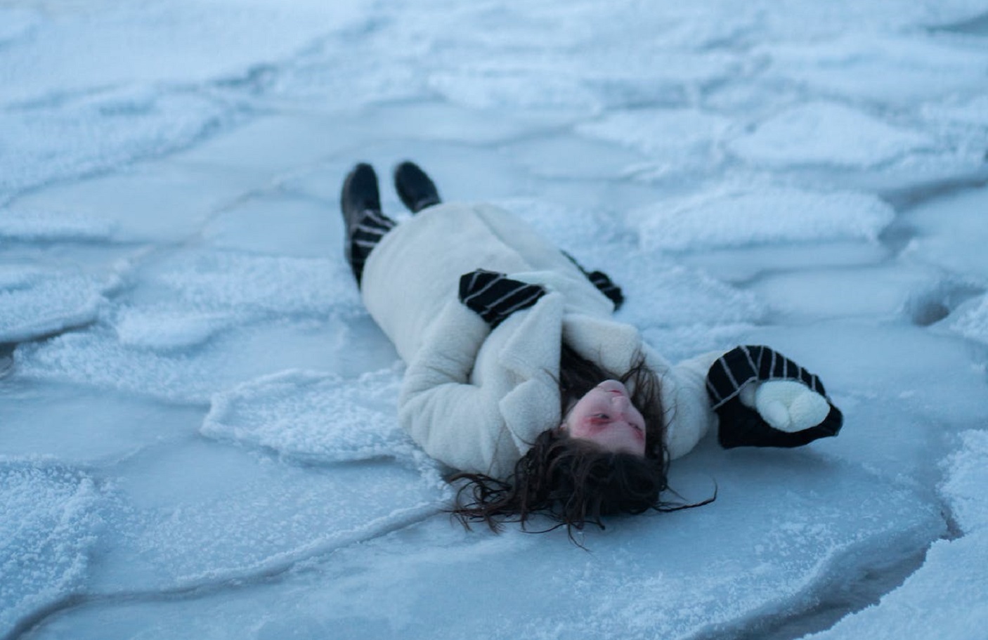 Frozen woman laying on the ground.