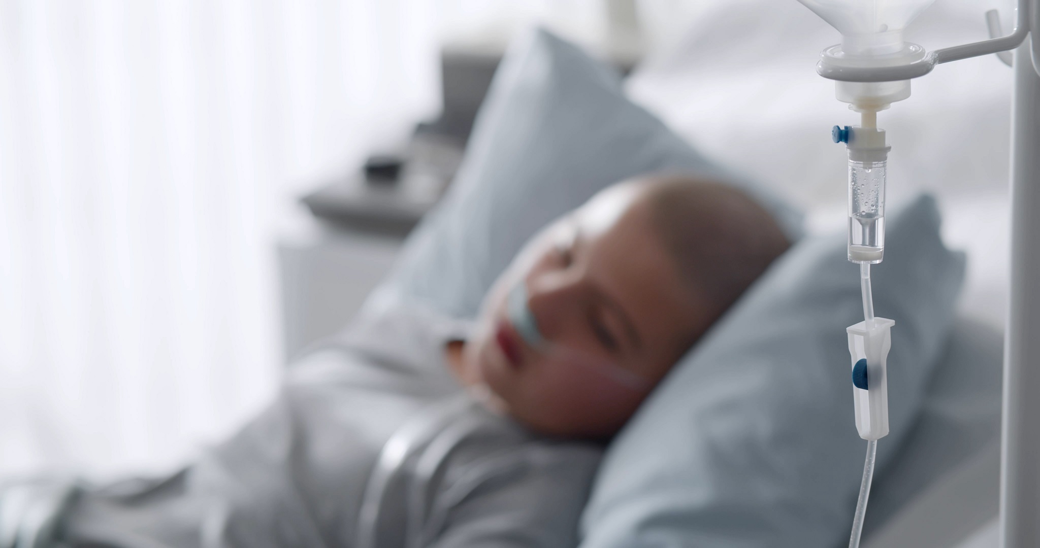 Sick teen in hospital bed.