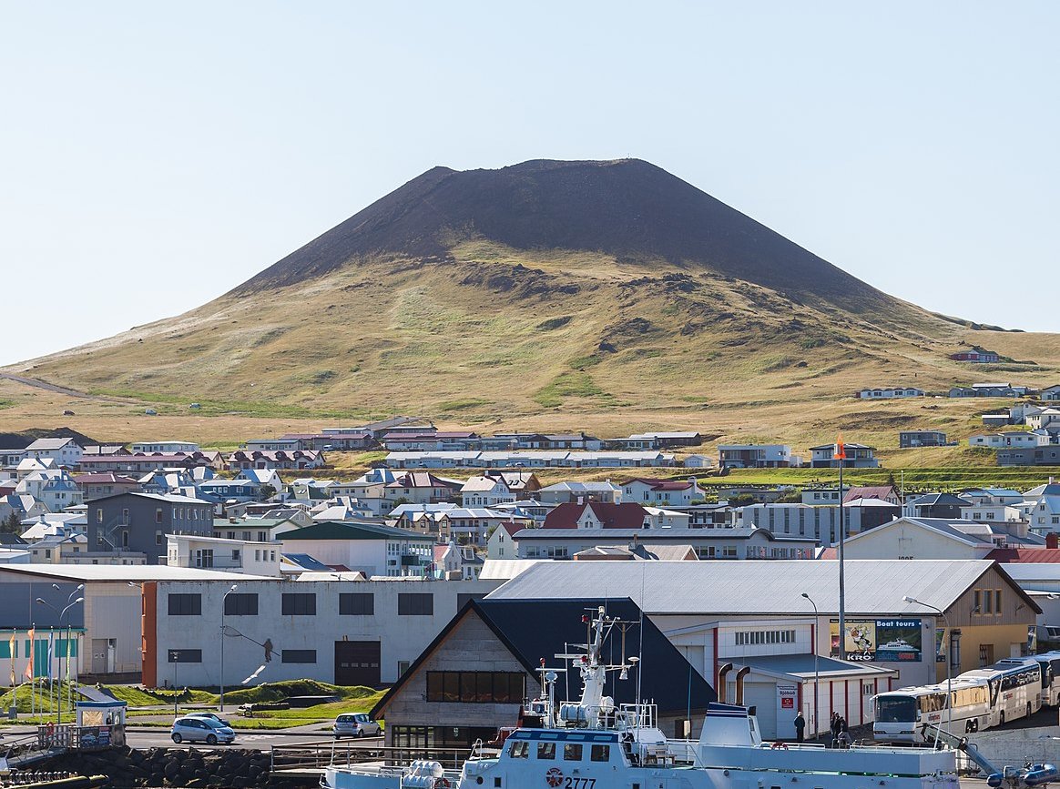 The cone of the dormant Helgafell volcano seen from Heimaey harbor