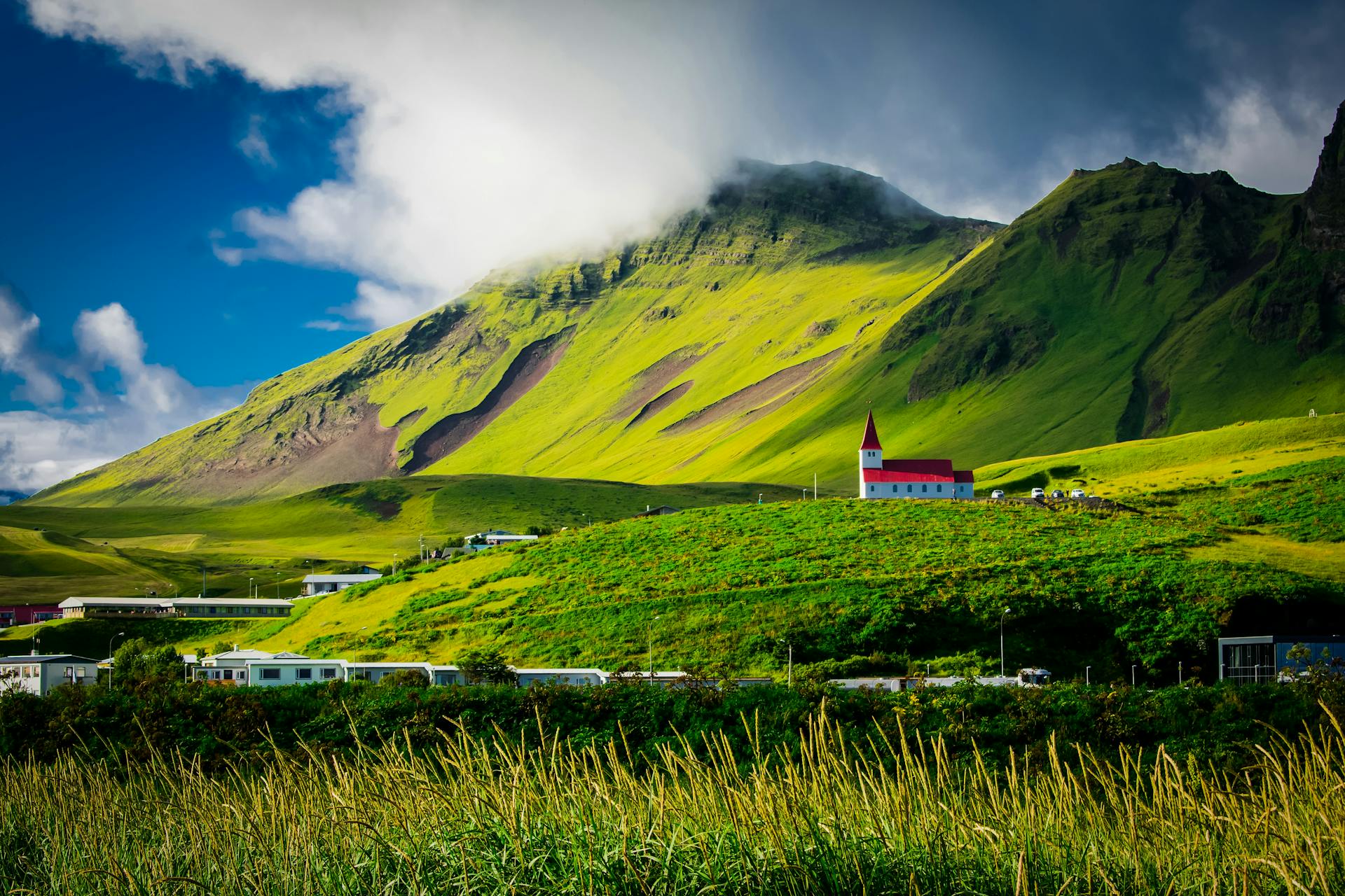 Landscape photo of a green field near mountain during daytime