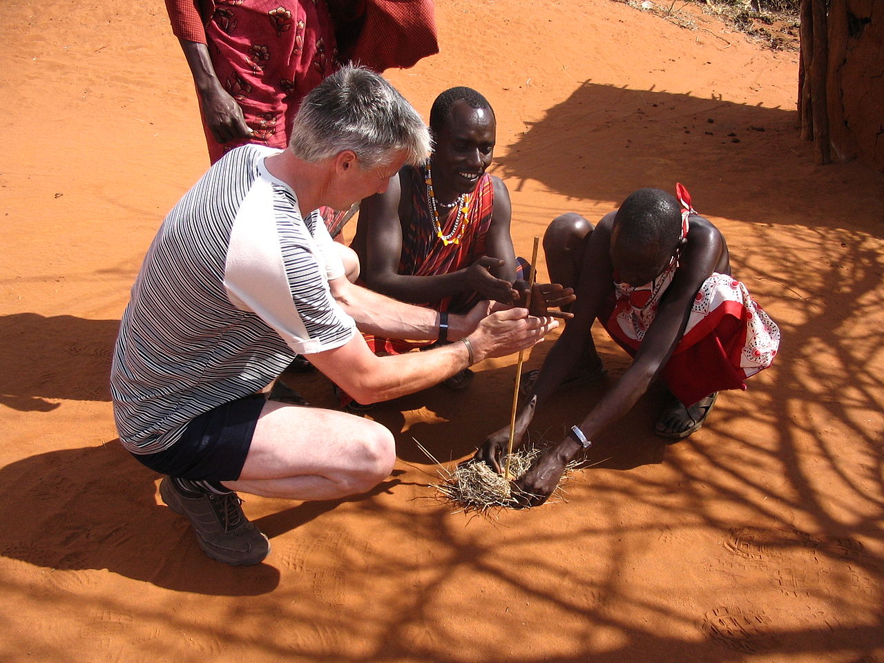 Maasai people and a tourist lighting a fire - 2005