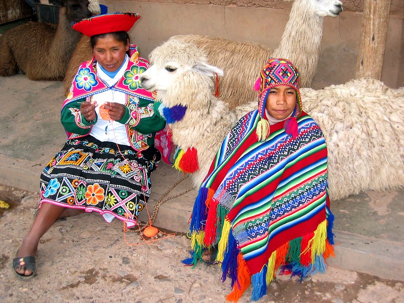 Quechua people with their llamas in a village above Cuzco