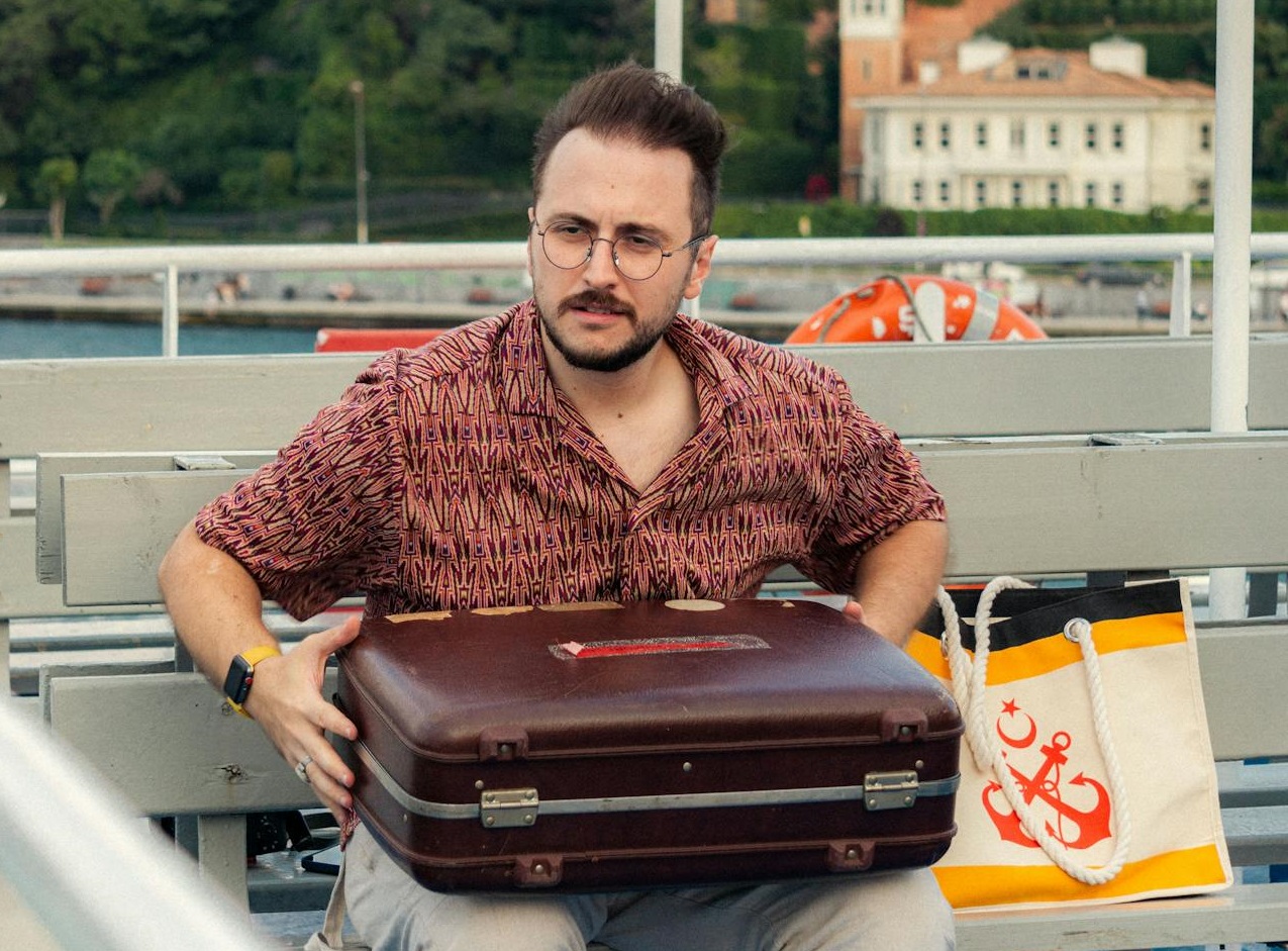 Man with a suitcase on a ferry.