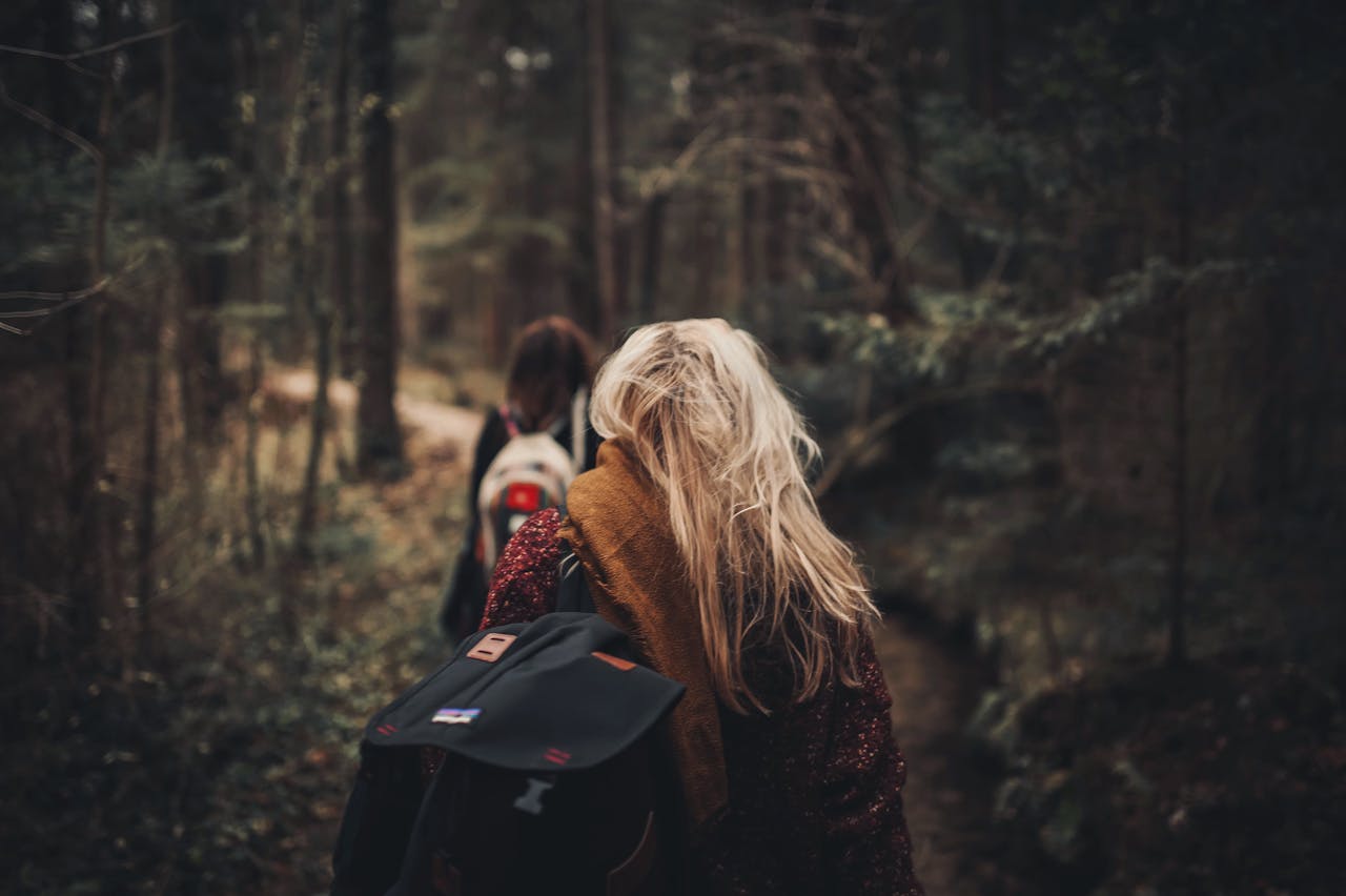 Girls are traveling in to the woods.