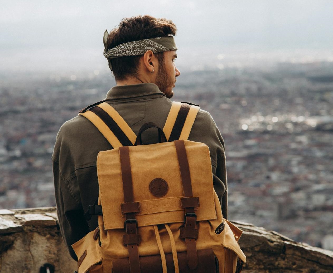Man with backpack looking at side.