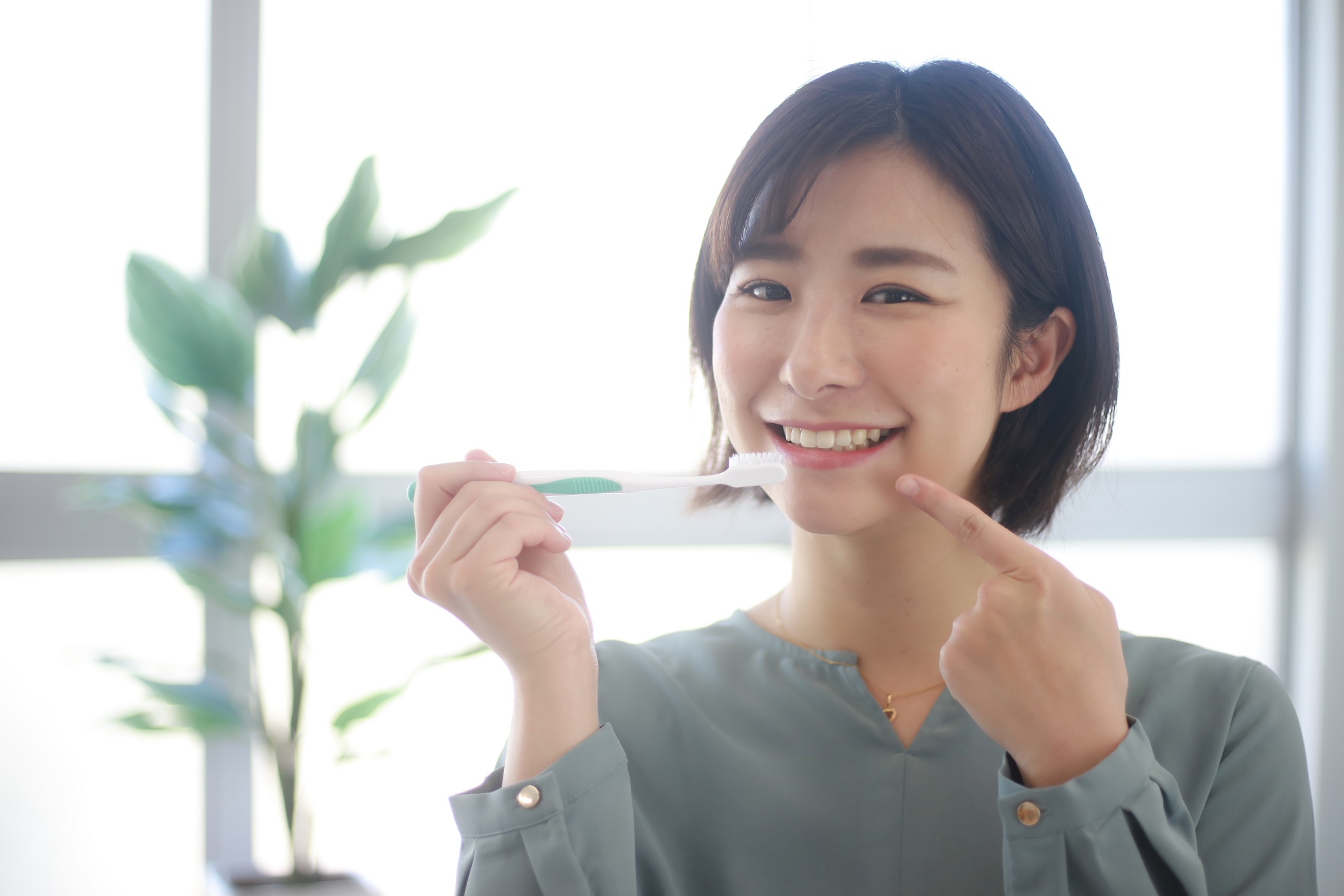 Image of a woman brushing her teeth