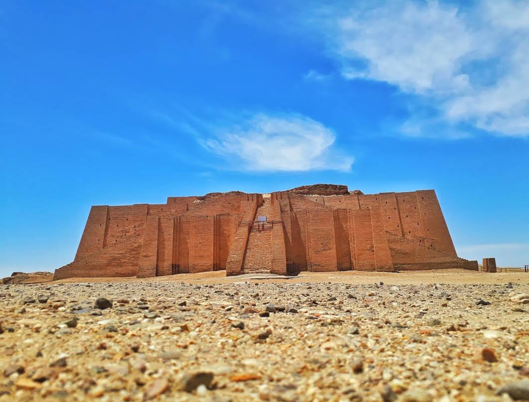 Ziggurat of Ur with bright blue sky and clouds in background