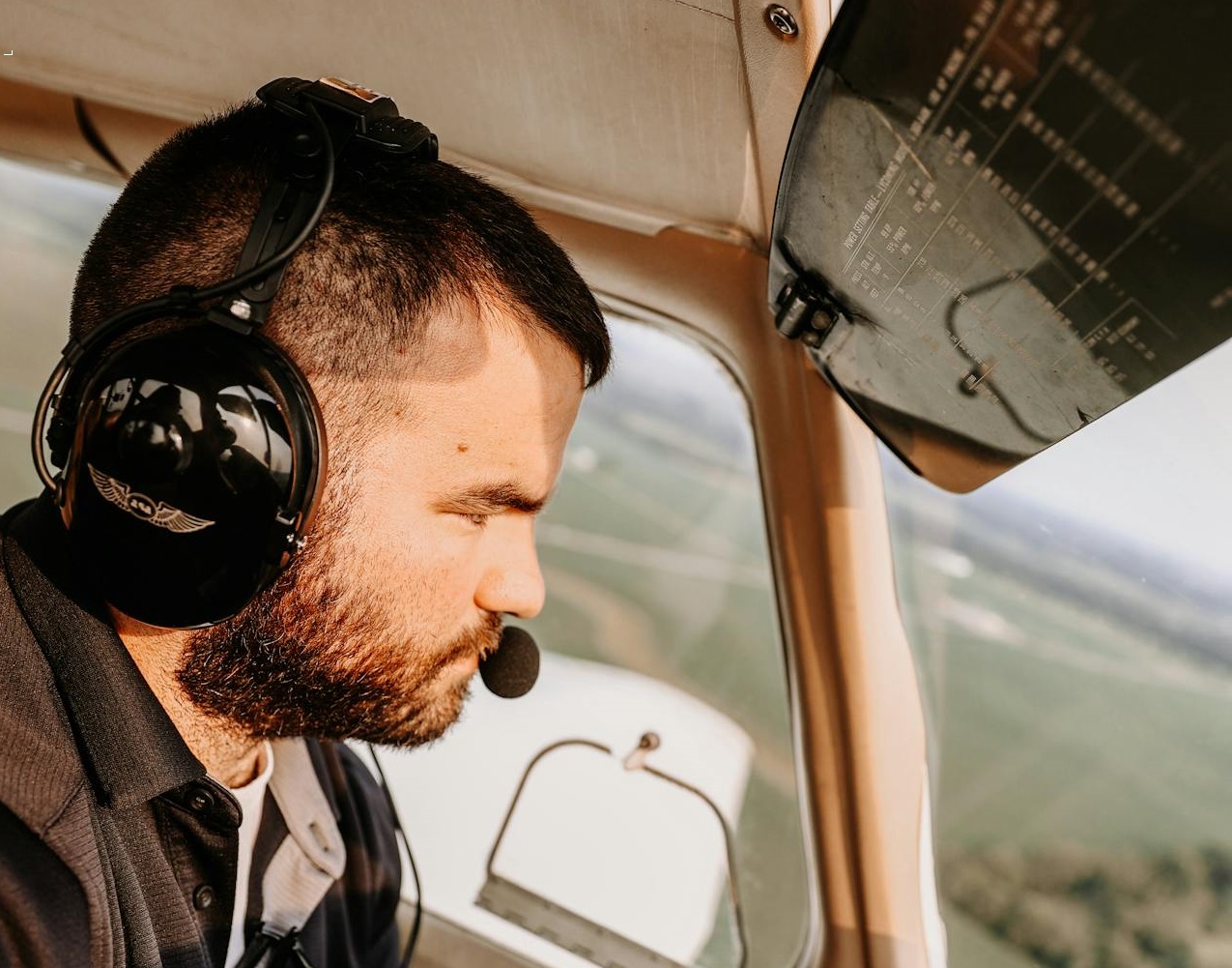 Pilot flying plane in the sky.